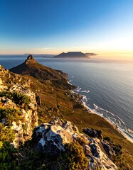 Coastal vista at dawn showcasing mountains, water, and radiant sunlight