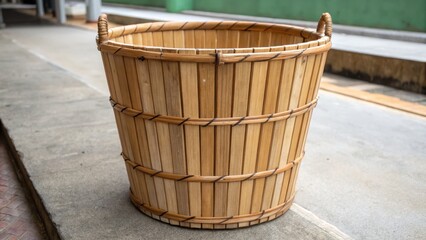 Naklejka premium 2026 zen new year tradition concept. Woven bamboo basket on a concrete surface.