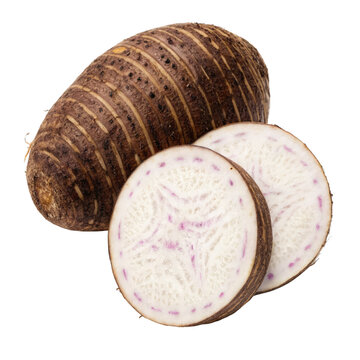 Whole taro root and two fresh slices revealing white flesh with purple veins on black background