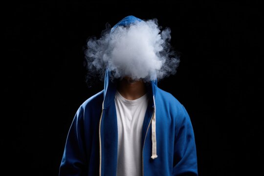Mysterious figure in blue hoodie exhales vapor against black background