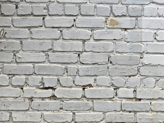 White brick wall with rustic texture and space for text suitable for design projects or backgrounds, located in an indoor area, no visible decor or features