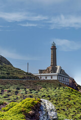 Historic Lighthouse Standing Tall on Rocky Cliff