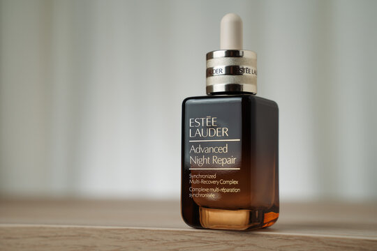 STRASBOURG, FRANCE - DECEMBER 11, 2025 : A still life photograph of the Estee Lauder Advanced Night Repair serum bottle displayed on a wooden surface.