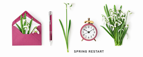 Composition with snowdrops, envelope, pen and alarm clock. Symbol of new beginning, fresh start and seasonal renewal