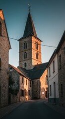 Historical urban landscape featuring the prominent tower of an old parish church constructed of stone, signifying the cultural center of the settlement, religion, parish, community