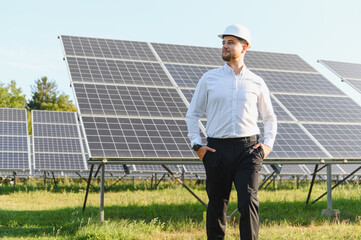 Engineer checking solar panels at power plant