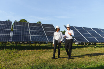 Engineers discussing solar panel installation at power plant