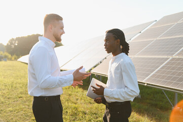 Engineers discussing solar energy project on field