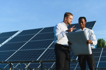 Engineers discussing blueprint for solar panel installation