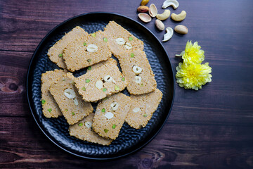 Til gajak, a traditional Indian winter sweet made with sesame seeds, jaggery, ghee, and dryfruits. Crunchy til chikki festive treat for Makar Sankranti. Tilgul. sesame candy. Copy Space. Winter food.