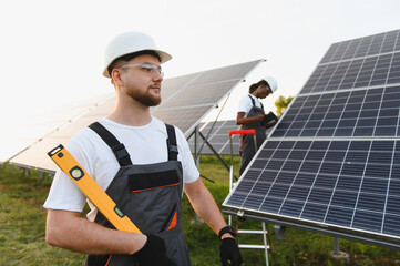 Fototapeta premium Engineers installing solar panels for renewable energy