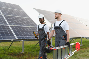 Solar technicians working at photovoltaic power station