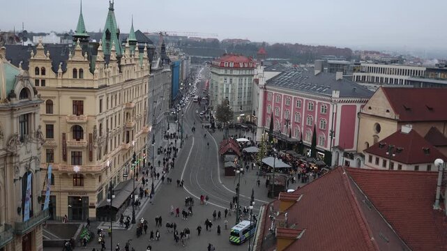 Evening Prague city center with tram tracks crowds walk between historic buildings Christmas market lights urban life travel atmosphere winter capital europe tourism vibe