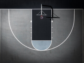 Aerial view of a basketball court with its stark black and grey contrasting tones creating a minimalist design, Boston, Massachusetts, United States.