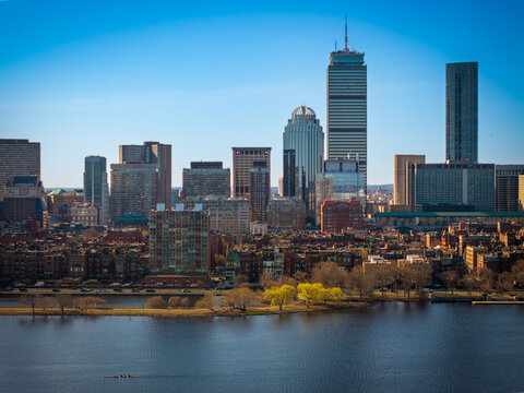 Aerial view of the John Hancock Tower and Prudential Center rise against the blue sky, reflected in the calm waters below, Boston, Massachusetts, United States.
