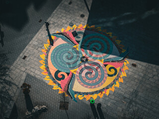 Aerial view of the vibrant and intricate swirling patterns of a colorful mural at the intersection of brick pathways, Boston, Massachusetts, United States.