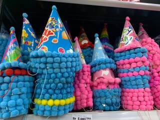 Colorful decorative ornaments knick knacks for birthday celebrations or religious celebration decorations sold in shops. The items include shiny, spherical red, green, gold, pink, and silver.