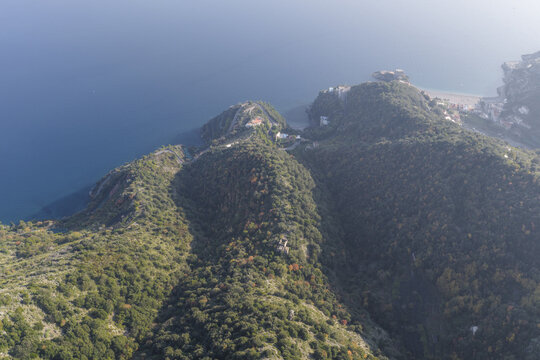 Aerial view of verdant hills cascading into the azure sea, a coastal haven where nature's palette blends seamlessly, Erchie, Amalfi Coast, Campania, Italy.