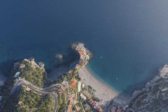 Aerial view of the beach and the buildings on the cliffs creating a striking contrast against the deep blue sea, Erchie, Amalfi Coast, Italy.