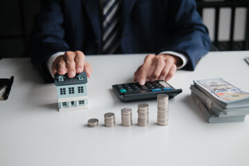 real estate agent calculates home loan and contract valuation in office