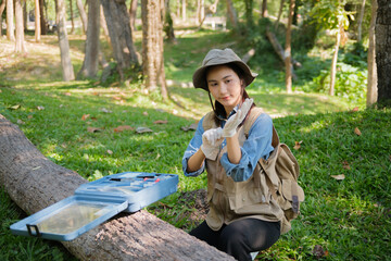 Female botanist researches grass and leaves in field to promote eco sustainability