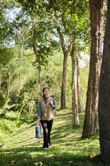 Female botanist observes plants and grass in field for eco agricultural research