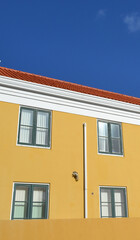 Yellow Wall with Colorful Windows in Curaçao