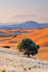 Fototapeta premium Breathtaking Rolling Hills Vista Featuring a Solitary Tree Against Distant Mountains at Golden Hour