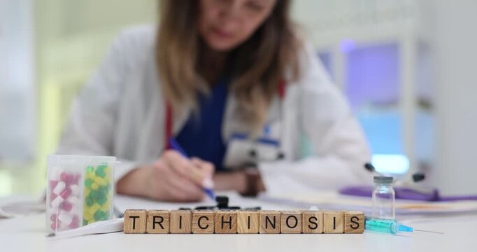 Wooden blocks spell word Trichinosis beside pills and syringe. Woman doctor writes parasitic infection notes monitoring muscle symptom history