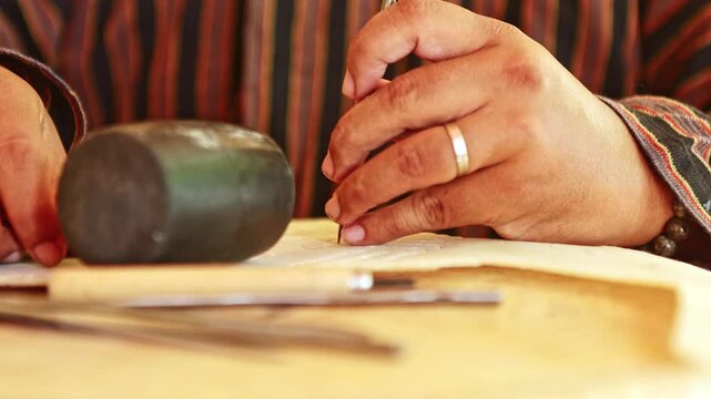 Artisan hands carving intricate details with tools