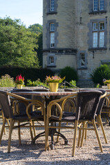 A nice street cafe in Europe with an old building on the background on the summer day