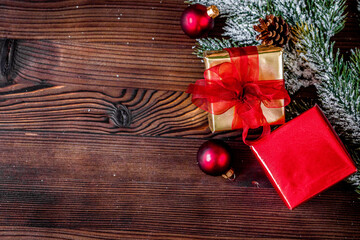 gifts boxes with fir branches on wooden background top view