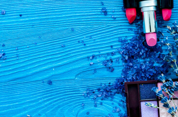 decorative cosmetics with lavender on wooden background top view