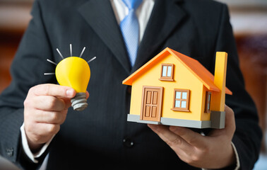 A light bulb and a private home. Energy supply and building autonomy. Smart home. Renovation. Energy efficiency solutions support independence, sustainability and modern housing upgrades.