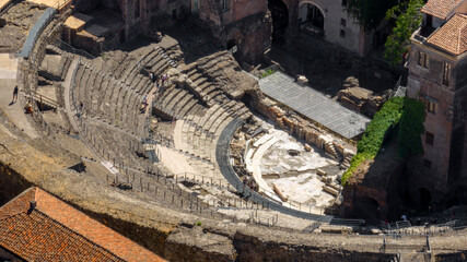 Fototapeta premium Aerial closeup of the Amphitheater of Catania, in Sicily, Italy. It is an ancient amphitheater in Southern Italy, built in the Roman Imperial period. It is located in the historic center of the city.