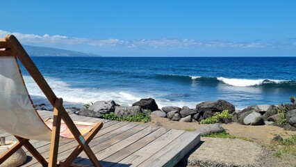 Ocean view on Sao Miguel Island, Azores, Portugal, with smooth waves and sun chair at the beach