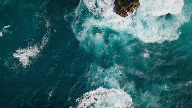 Top down aerial view of ocean waves breaking over lava reefs and rocks, Atlantic Ocean, Azores