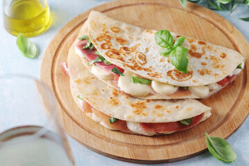 Traditional Italian dish Piadina romagnola - flat bread with mozarella and proscuitto	