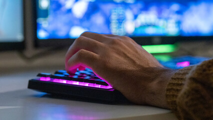 Close-Up of a Young Gamer Playing on a Gaming Keyboard  © Sanlad