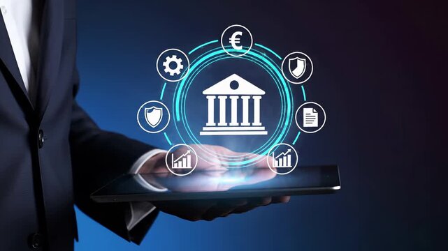 Business professional with tablet and virtual banking interface featuring bank building surrounded by financial service symbols including euro currency, security shields, analytics charts, documents