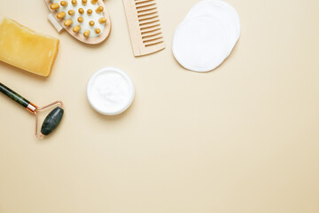 Skincare set with marble roller, gua sha, wooden body brush, facial cream and serum for natural beauty care