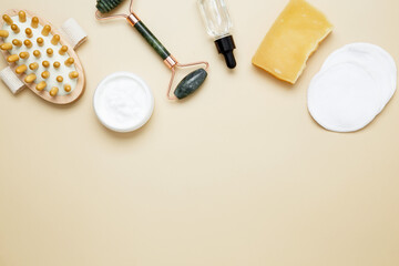 Skincare set with marble roller, gua sha, wooden body brush, facial cream and serum for natural beauty care