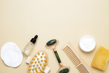 Skincare set with marble roller, gua sha, wooden body brush, facial cream and serum for natural beauty care