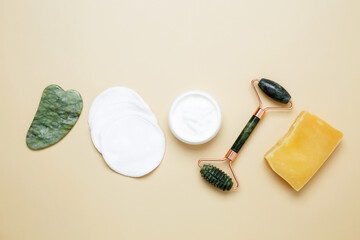 Skincare set with marble roller, gua sha, facial cream for natural beauty care