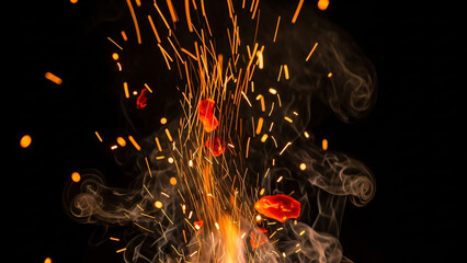 a close up of a fire with a bunch of red flowers on it