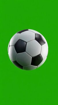 Football or soccer ball rotating on green screen 4K stock vertical video.