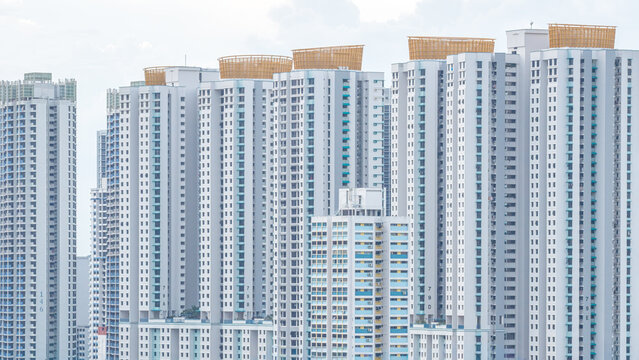Aerial view of towering HDB flats reach towards the sky, their pale facades punctuated by the rhythmic grid of windows, Lorong 6 Toa Payoh, Singapore, Singapore.