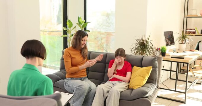 Emotional mother complains on teen daughter behavior at psychologist appointment. Woman and angry girl visit specialist to solve problem in office