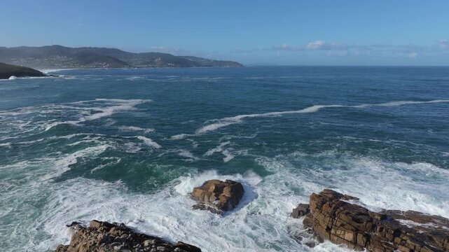 Rock And Waves Near Senda Azul (Paseo Mar&iacute;timo de Arteixo) Coastal Hike In Arteixo, A Coru&ntilde;a, Galicia, Spain. Aerial Pullback Shot