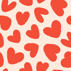 Seamless pattern of red hand drawn romantic hearts on a beige background. Design elements for Valentine's Day. Vector illustration